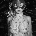 Stonetree Creative - Black and white portrait of half nude woman with pearls and bunny mask
