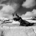 Stonetree Creative - Black and white image of a valkyrie laying on an iceberg holding a sword in Iceland