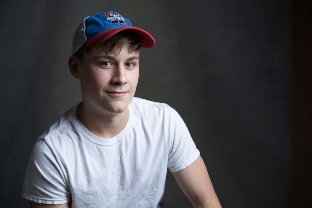 senior picture of young man in pabst blue ribbon hat