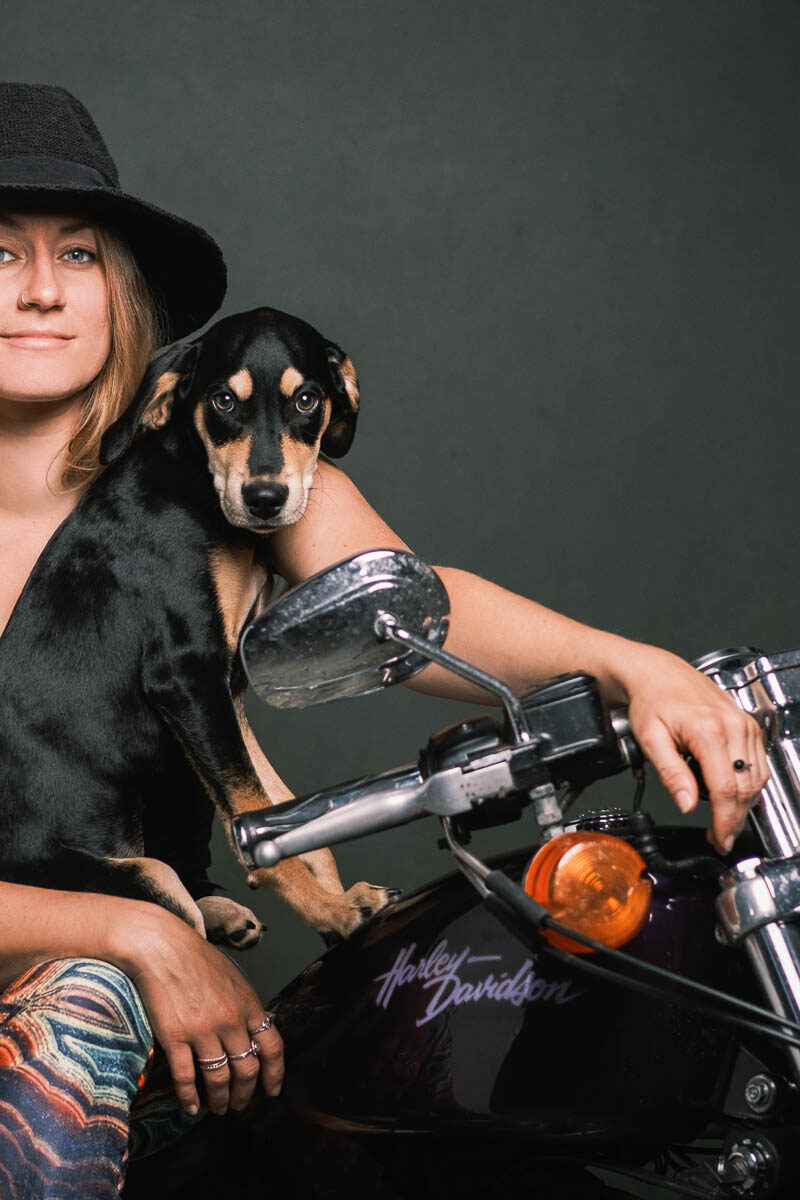 woman on motorcycle with puppy