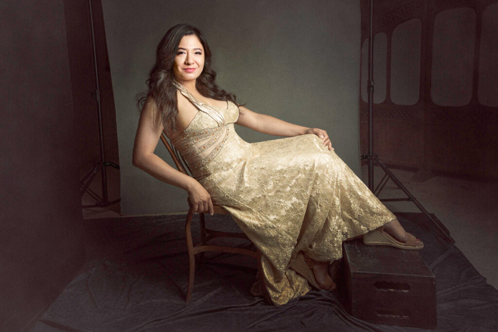 woman in gold dress sitting in chair