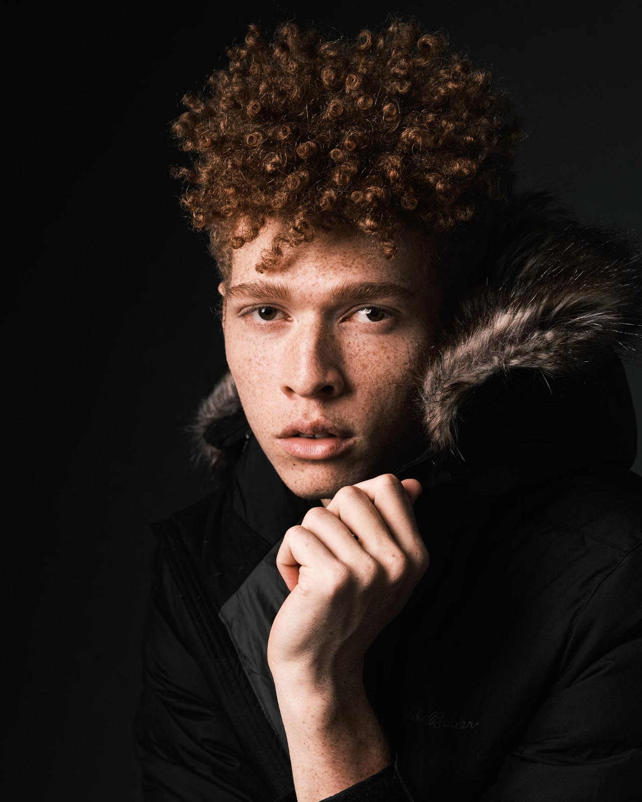 portrait of boy with fur coat and curly red hair