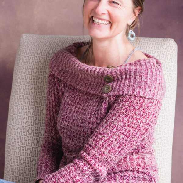 woman in pink sweater laughing
