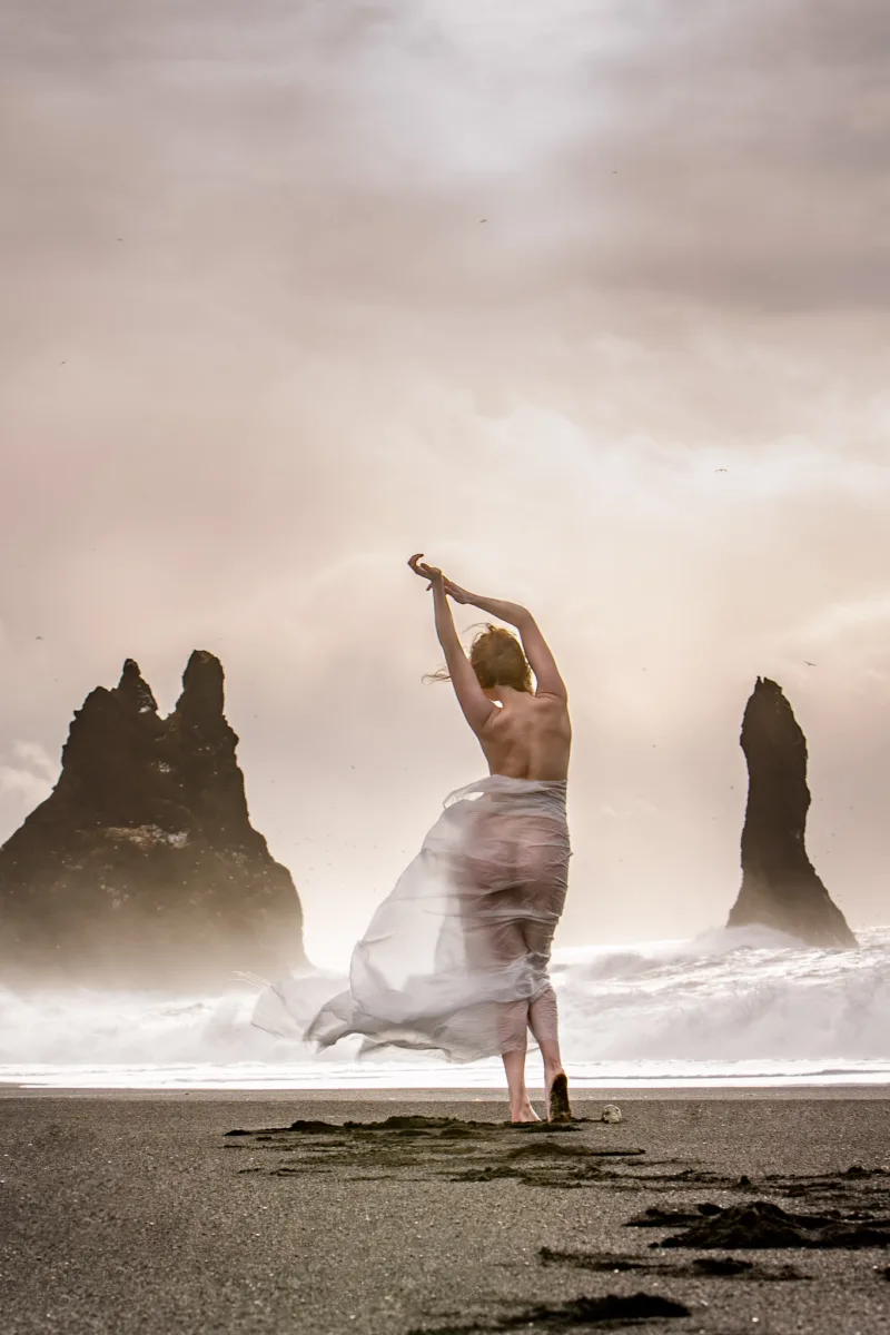 woman dancing on beach in iceland
